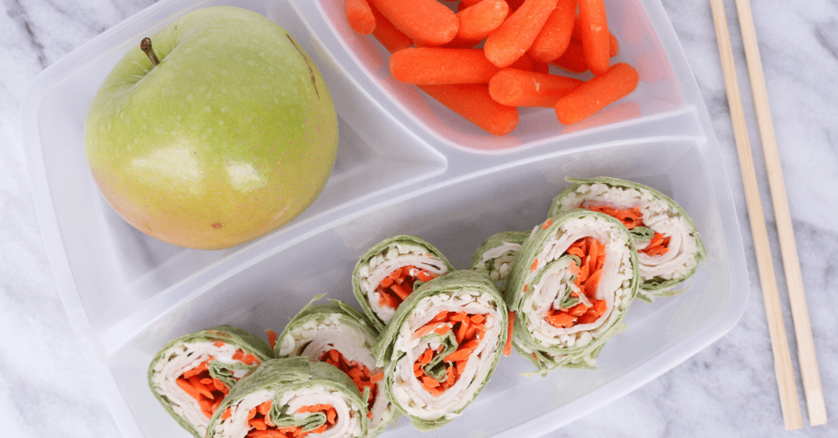 apple carrots and wraps in a tray
