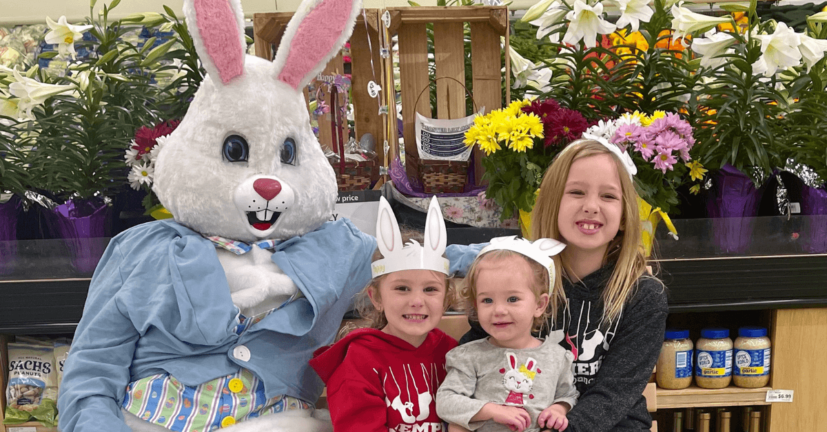 easter bunny sitting next to children
