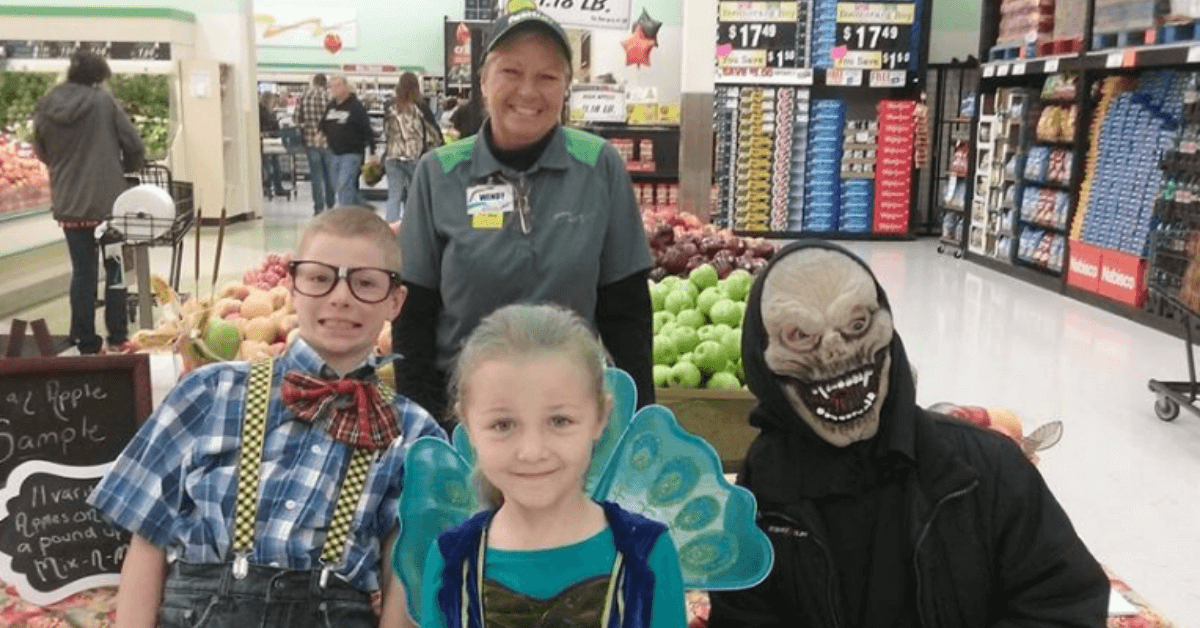 children wearing halloween costumes with Festival Foods employee