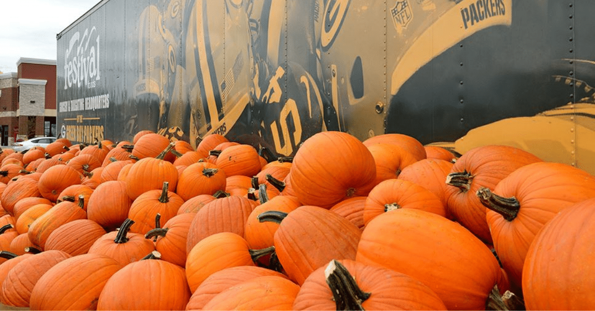 Stack of pumpkins in front of semi truck