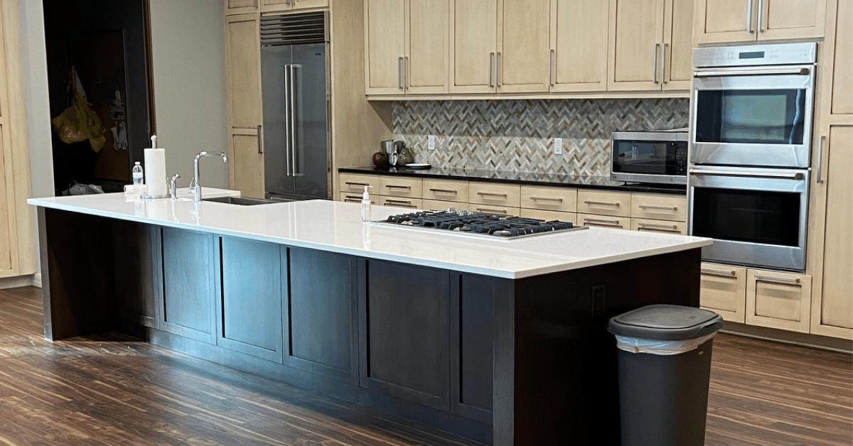 Kitchen counter with oven and cabinets in the background