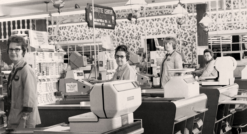 ladies standing next to cash registers
