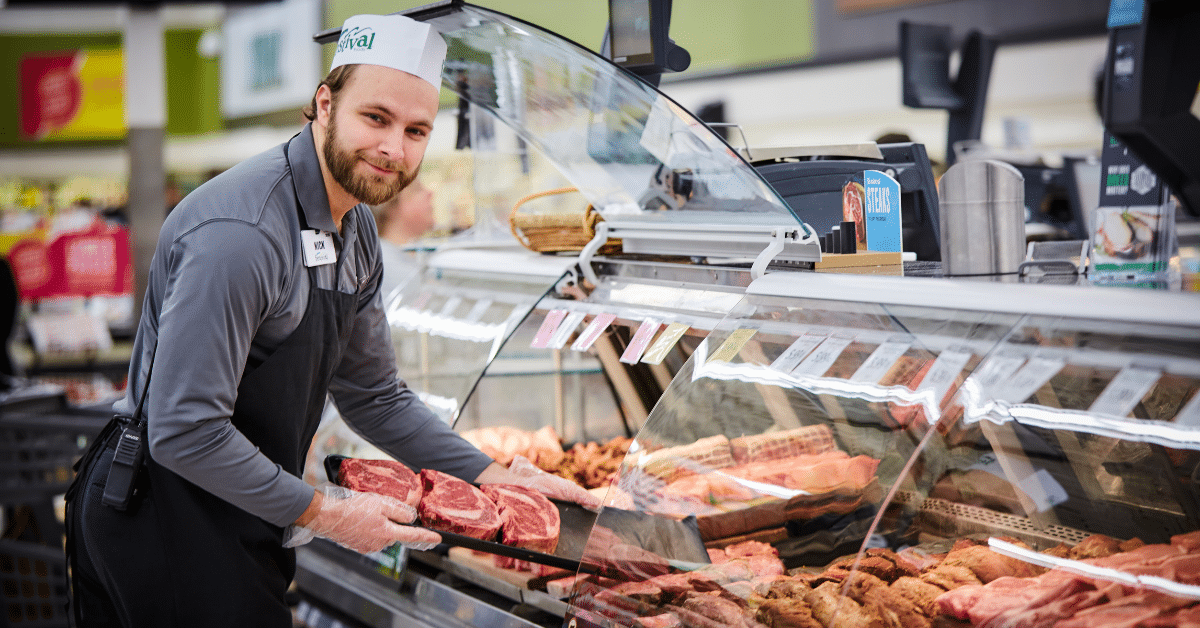 associate next to meat counter