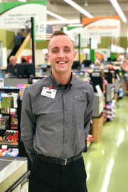 man standing next to cash registers